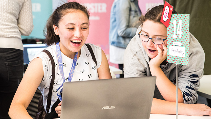 Image of two teenage girls taking part in Girl Geek Academy, working on a laptop